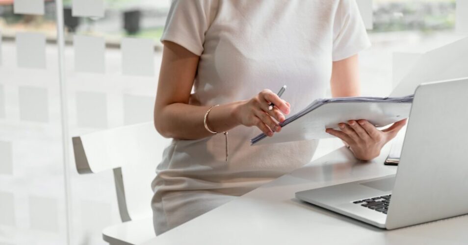 Audit working, Businesswoman work with paper document on clipping board in office